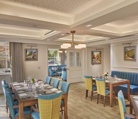 Bright dining room with tables set for residents