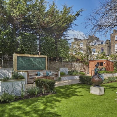 A beautifully maintained outdoor garden space with sculptures