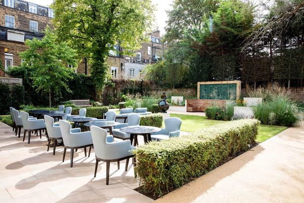 Outdoor garden area with seating and greenery