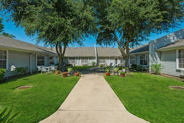 Walkway through the courtyard with seating and greenery at Lucas Court.