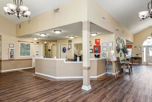 Bright reception area with a front desk and seating at Lucas Court.
