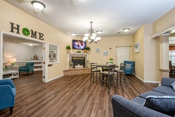 Bright and inviting common area with seating and a fireplace.