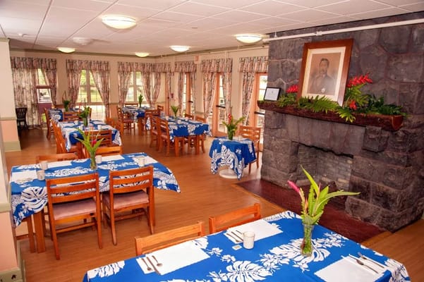 Bright dining room with blue tablecloths and floral decorations