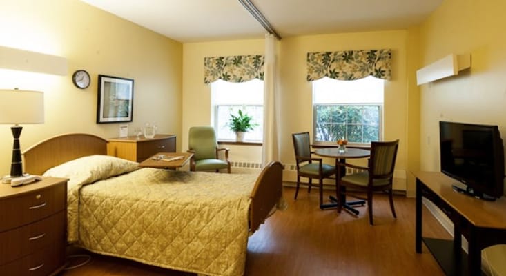 Cozy private resident room with a bed and sitting area