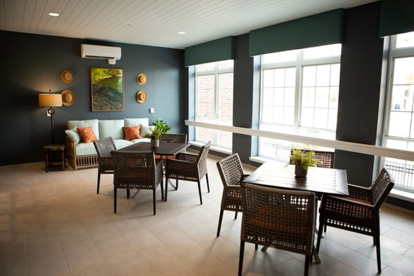 Bright common area with comfortable seating and windows