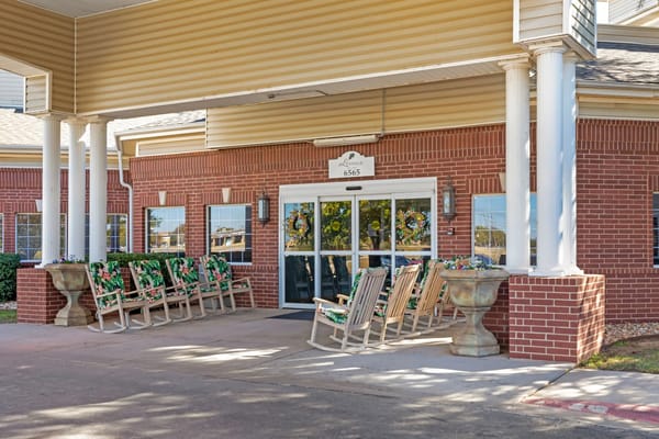 Outdoor seating area with rocking chairs at the entrance