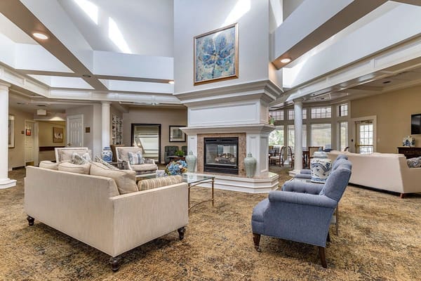 Cozy common area with seating and a fireplace in Lyndale Edmond Senior Living.