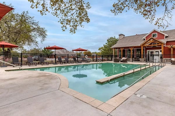 A tranquil outdoor pool with loungers and umbrellas.