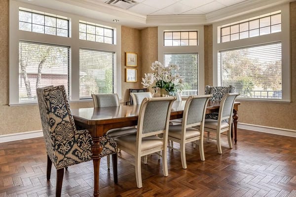 Elegant dining room with a large wooden table and comfortable chairs
