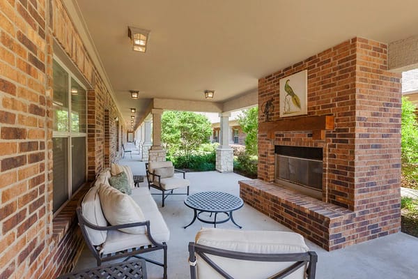 Outdoor seating area with a fireplace and landscaping