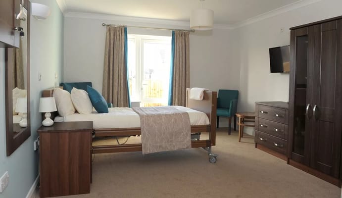 Private resident room with adjustable bed and furnishings