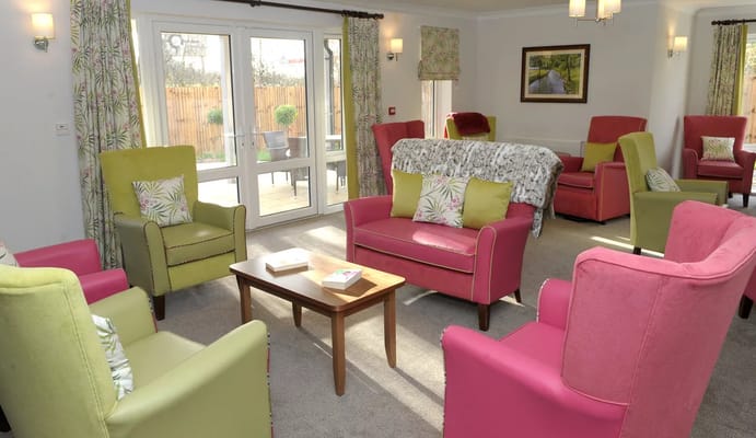 Bright common area with colorful seating and natural light
