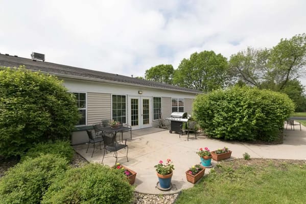 Outdoor patio area with seating and greenery