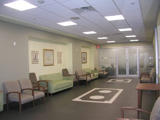 A bright lounge area with seating and art on the walls