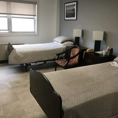 Shared resident room with two beds and bedside tables