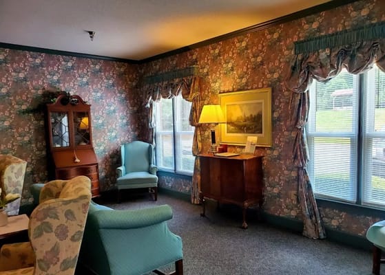 Cozy common area with floral wallpaper and seating