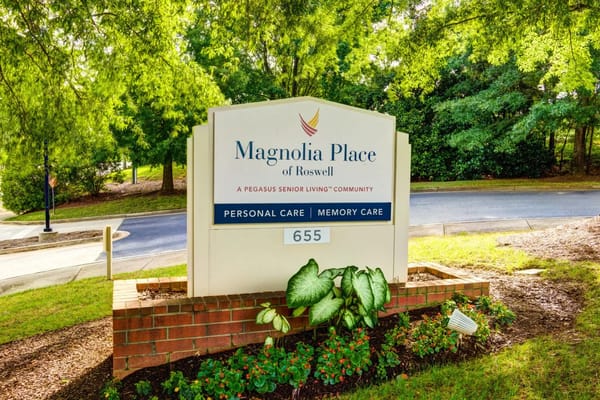 Sign of Magnolia Place of Roswell in a landscaped area