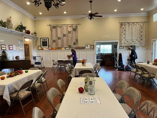 Residents interacting in a common area with tables and decorations