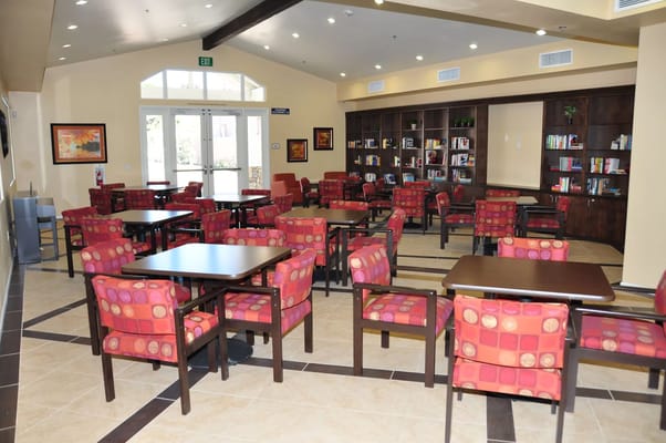 Common area with colorful seating and bookshelves