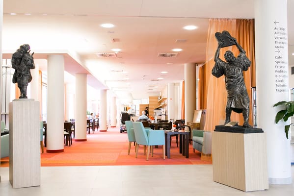 Spacious lobby featuring sculptures and seating for residents