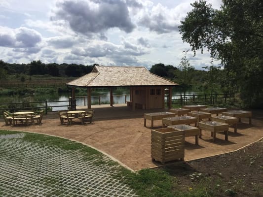Outdoor seating area by a serene pond