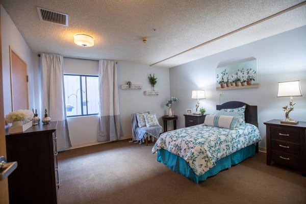 A cozy resident room with floral decor and soft lighting