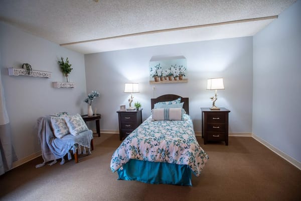 Cozy private resident room with floral bedding and decor
