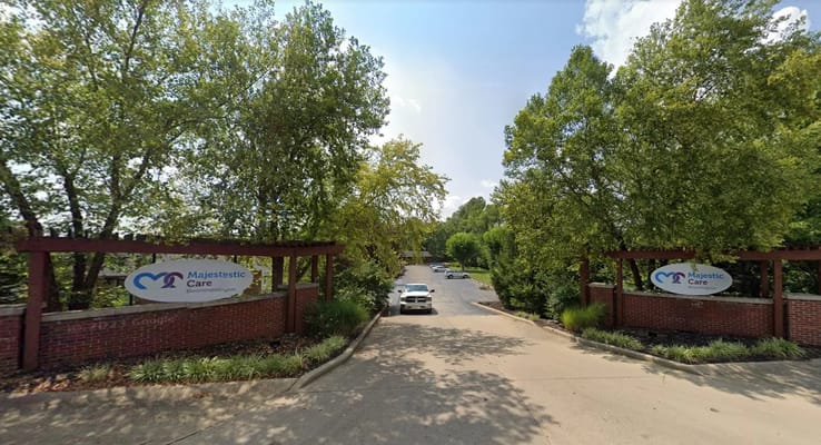 Entrance to Majestic Care of Bloomington with signage and trees