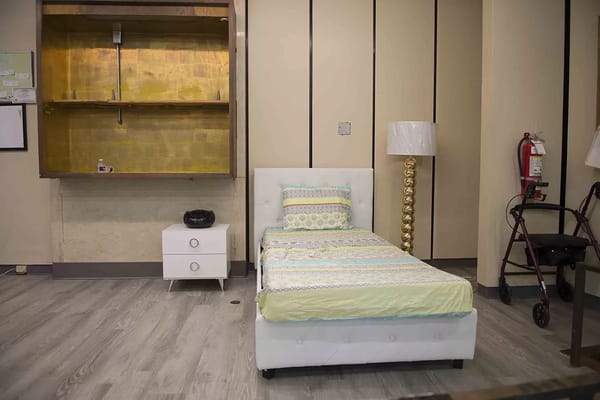 Interior view of a resident room with bed and decor