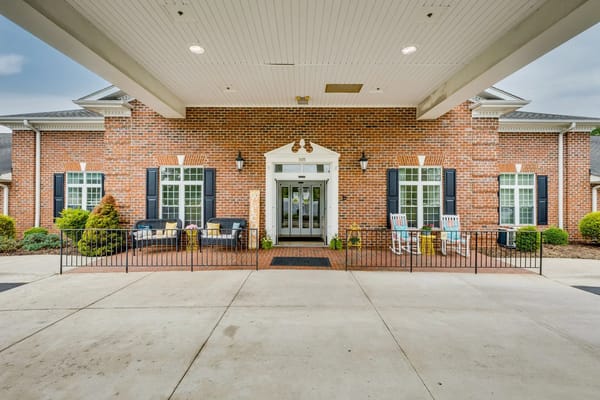 Entrance of Mallard Ridge senior living facility with outdoor seating.