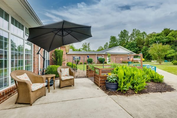 Outdoor patio with seating and garden at Mallard Ridge.