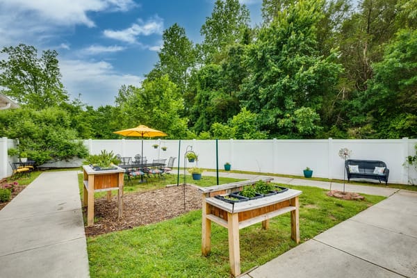 Garden with raised beds and seating area at Mallard Ridge.