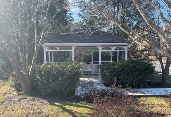 Outdoor gazebo surrounded by greenery