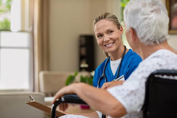A nurse talking to an elderly patient in a cozy room