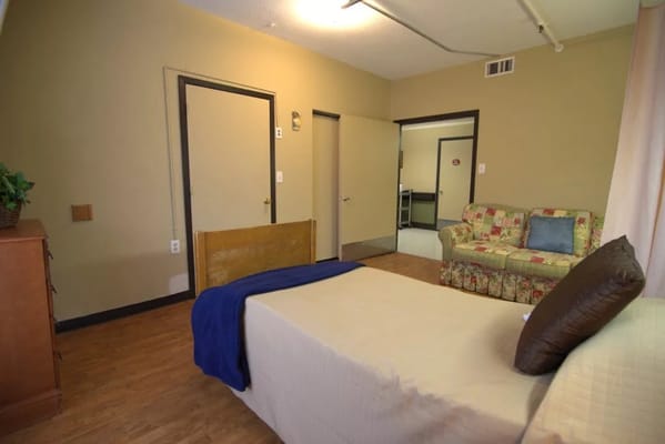 Interior view of a cozy resident room with a bed and sofa