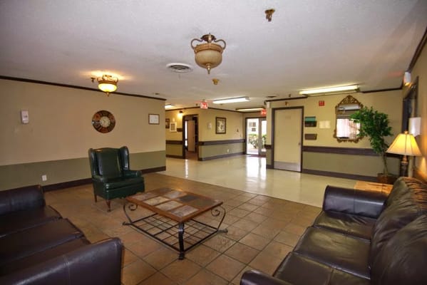 Seating area in the lobby with couches and a green chair
