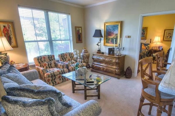 A cozy living room featuring patterned seating and soft lighting.