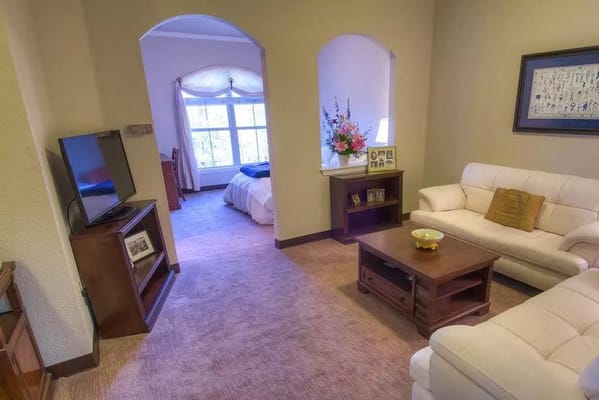 Bright living area with a view of a bedroom