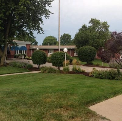 Exterior view of the Maple Crest Health Center surrounded by greenery
