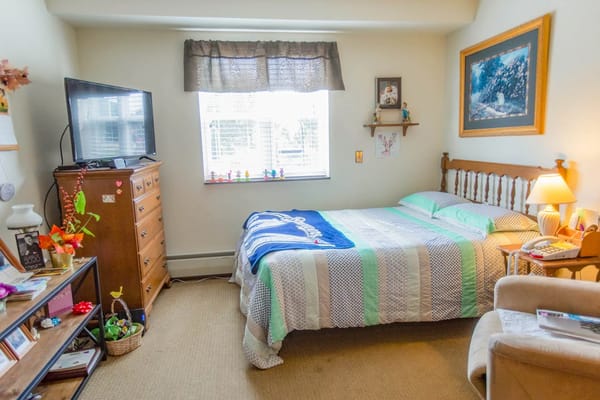 Cozy resident room with a bed and personal items