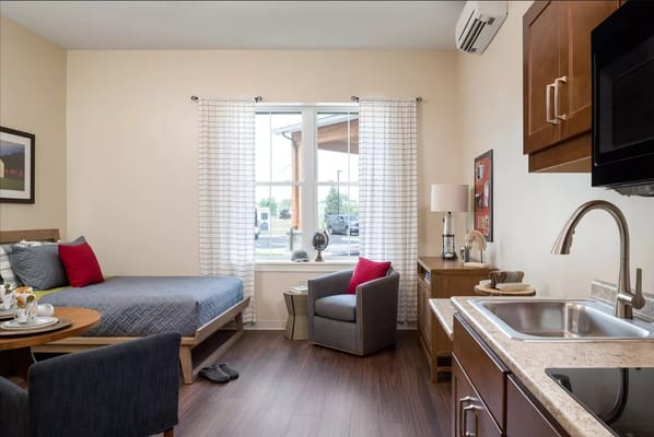 Cozy resident room with a kitchenette and seating area