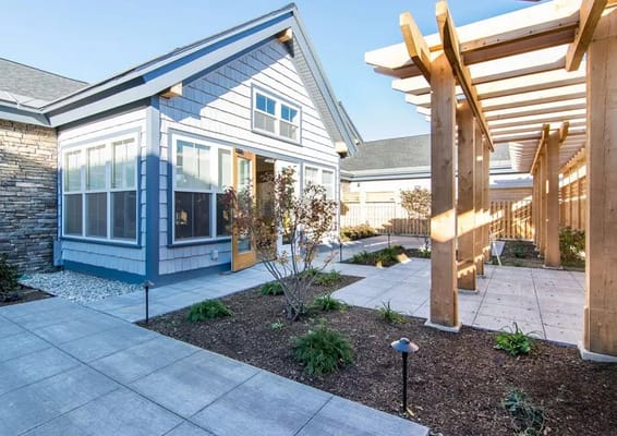 Exterior view of a memory care facility with gardens