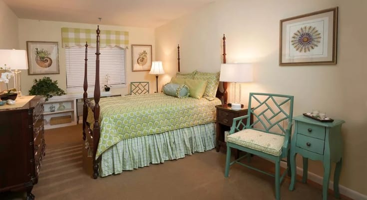 A well-furnished bedroom with a green-themed decor.