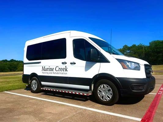 Facility transport van parked on a sunny day