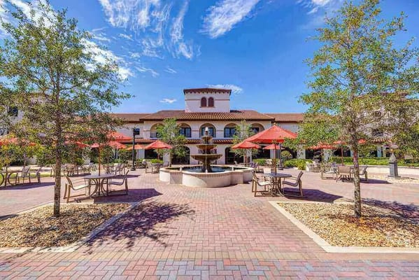 Outdoor seating area with a fountain and umbrellas