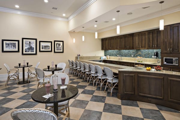 Bright dining area with seating and fruit on display