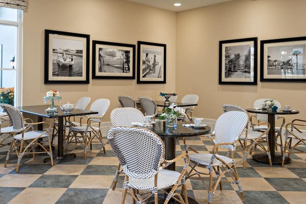 Bright interior with chairs and framed photographs