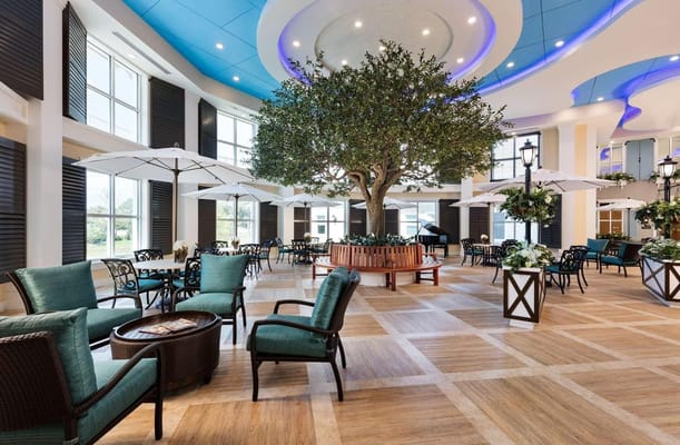 Bright common area with seating and tree centerpiece