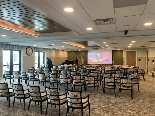 Interior view of a spacious activity room with chairs arranged