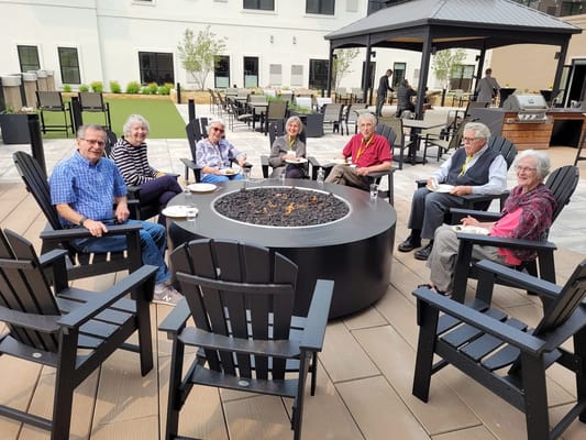 Residents enjoying a gathering around a fire pit